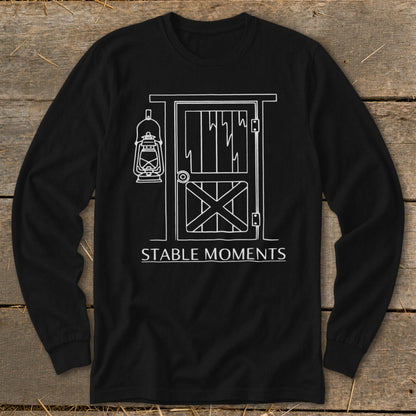 Black long-sleeve shirt with white line art of a barn door and lantern, reading "STABLE MOMENTS."