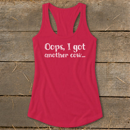 Pink racerback tank top with white text that reads "Oops, I got another cow..."
