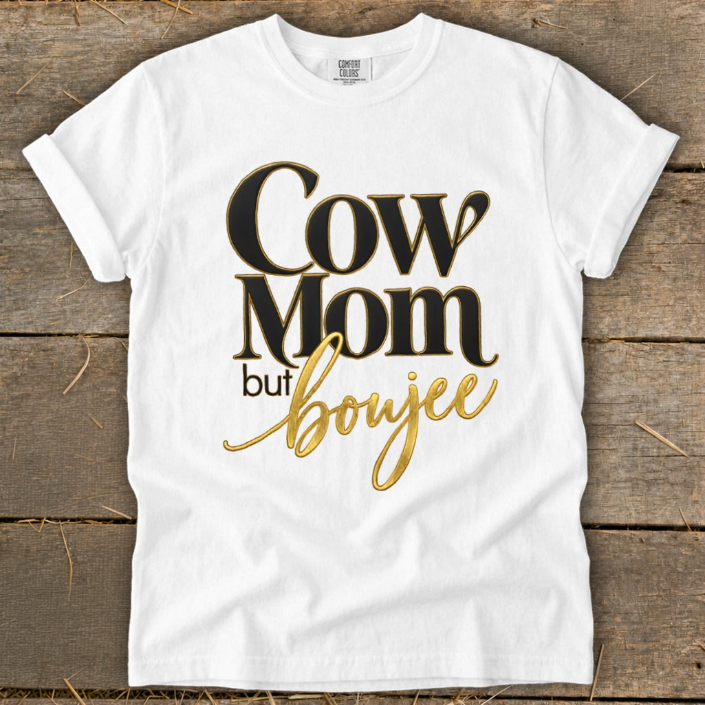 White t-shirt with black and gold text reading "Cow Mom but boujee".