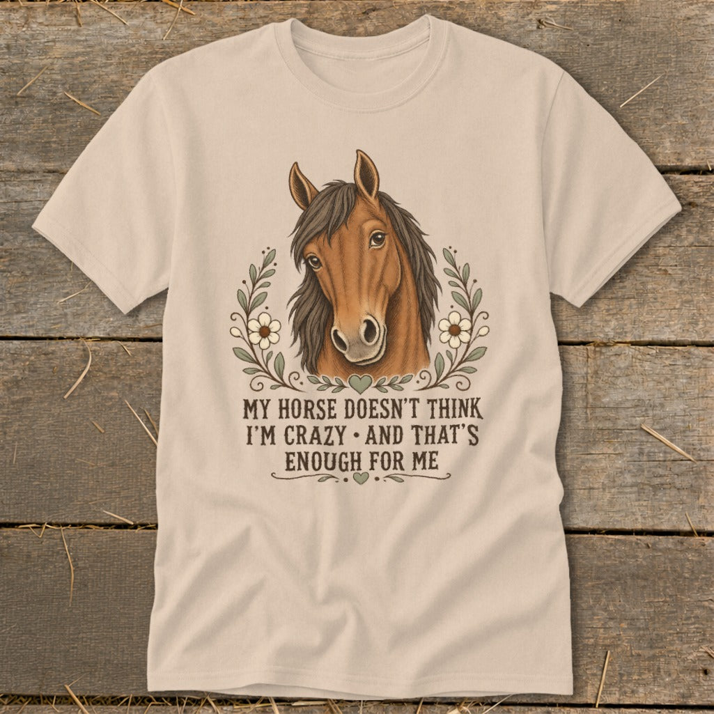 Light tan t-shirt with a horse illustration and text: "MY HORSE DOESN'T THINK I'M CRAZY AND THAT'S ENOUGH FOR ME."