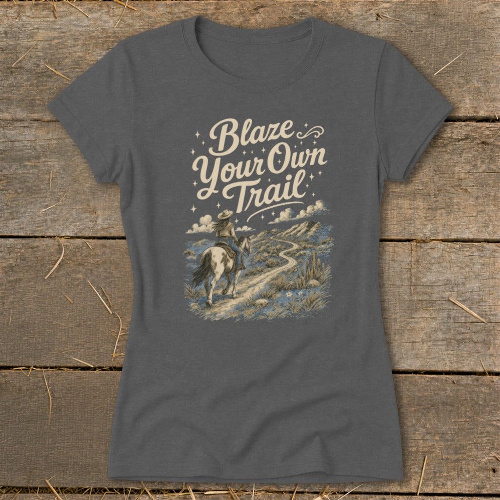 T-shirt with "Blaze Your Own Trail" text and horseback rider in desert landscape.