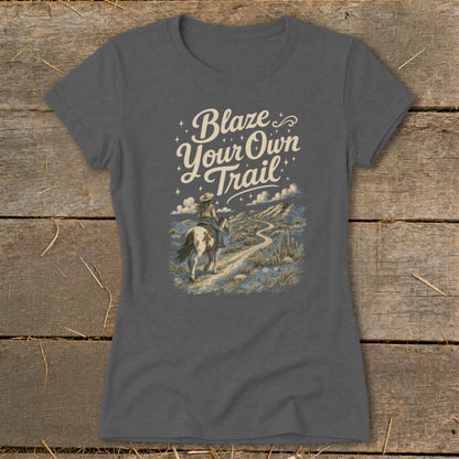 T-shirt with "Blaze Your Own Trail" text and horseback rider in desert landscape.