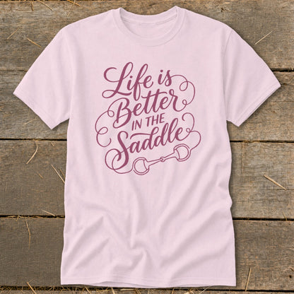 Light pink t-shirt with purple text that reads "Life is Better in the Saddle".