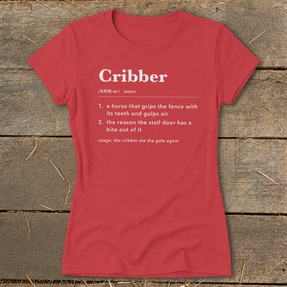 A red women's t-shirt printed with a humorous dictionary definition of the word Cribber in white text.