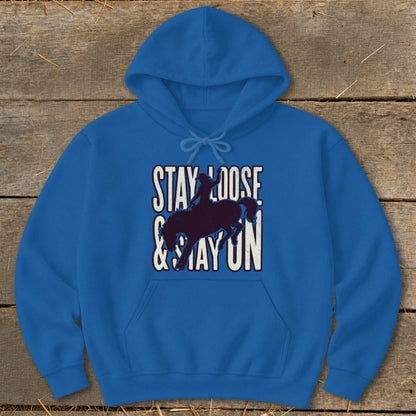 Blue hoodie with "Stay Loose & Stay On" text and bucking bronco silhouette.