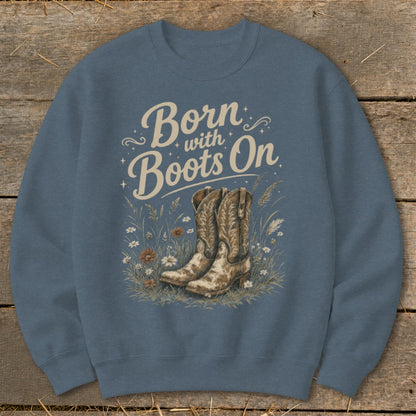 Sweatshirt with "Born with Boots On" text and cowboy boots in a field of flowers.