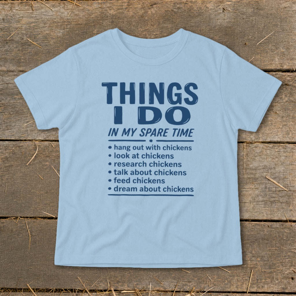 Light blue t-shirt with dark blue text listing chicken-related activities.