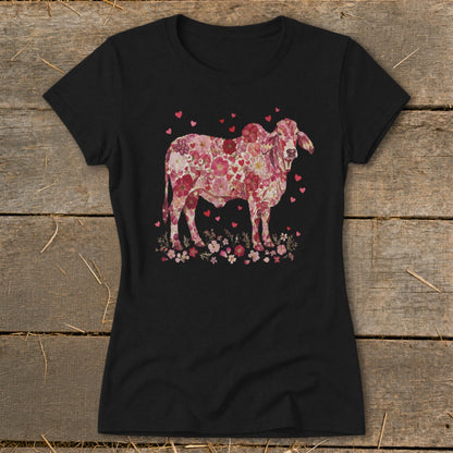 Black t-shirt featuring a floral print cow with hearts and flowers.