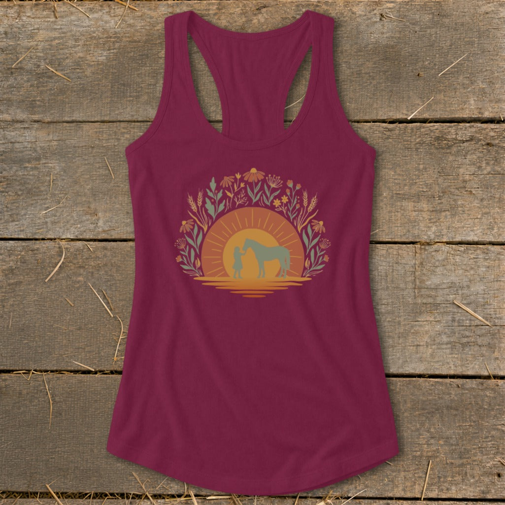 Maroon tank top with a circular graphic of a child and horse at sunset with wildflowers.