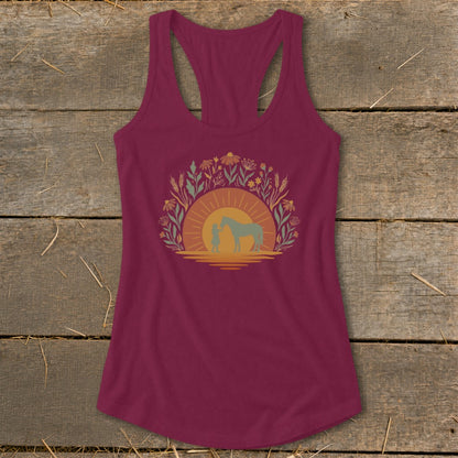 Maroon tank top with a circular graphic of a child and horse at sunset with wildflowers.