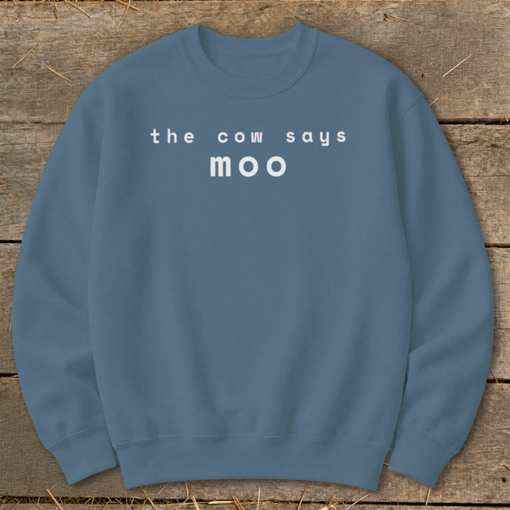 Blue sweatshirt with "the cow says moo" printed in white text.