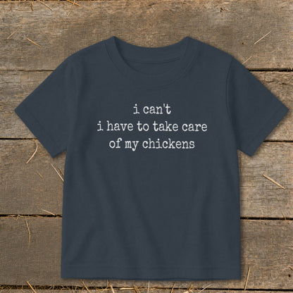 Dark blue t-shirt with white text "i can't i have to take care of my chickens".