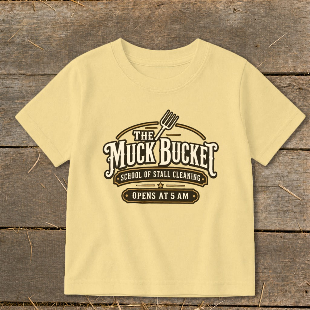 Yellow t-shirt with "The Muck Bucket School of Stall Cleaning Opens at 5 AM" graphic.