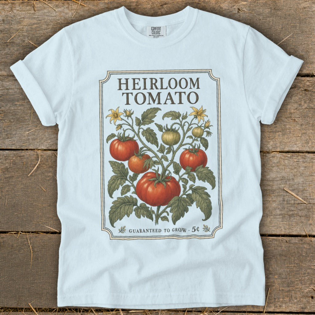 White t-shirt with "Heirloom Tomato" seed packet design.