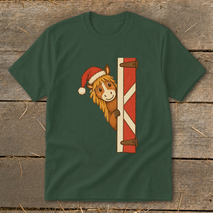 Green t-shirt with a cartoon horse wearing a Santa hat peeking from behind a barn door.