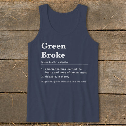 Dark blue tank top with white text defining "Green Broke" laid on wood.