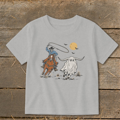 Skeleton cowboy on horseback chasing a ghost steer under a full moon.