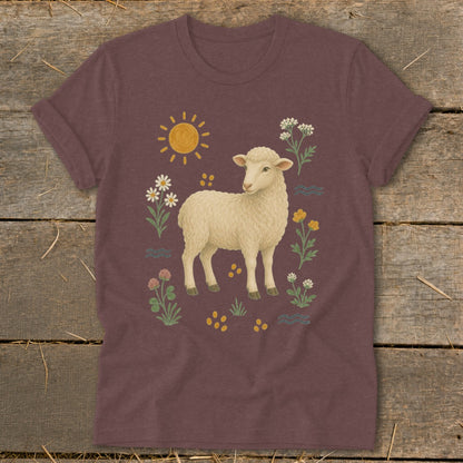 T-shirt with a cream sheep, sun, and floral illustration.