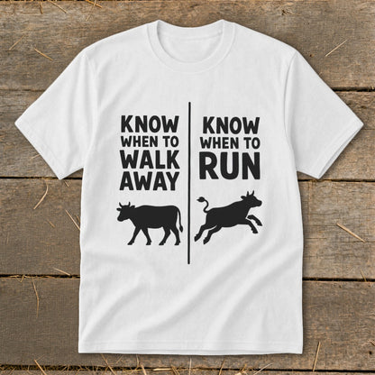 White t-shirt with "Know When to Walk Away" and a walking cow, and "Know When to Run" with a running cow.