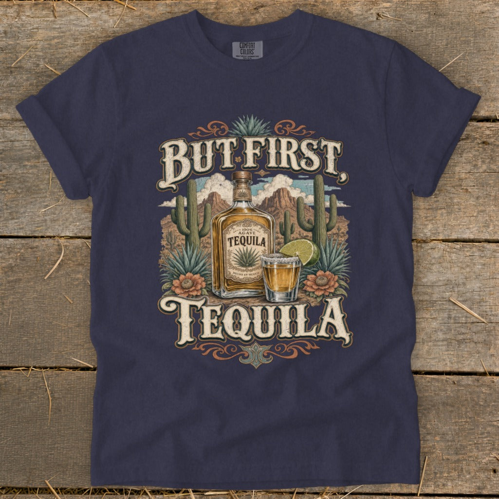 Dark blue t-shirt with "But First Tequila" text, agave bottle, shot glass, and desert scene.