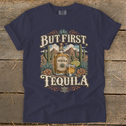 Dark blue t-shirt with "But First Tequila" text, agave bottle, shot glass, and desert scene.