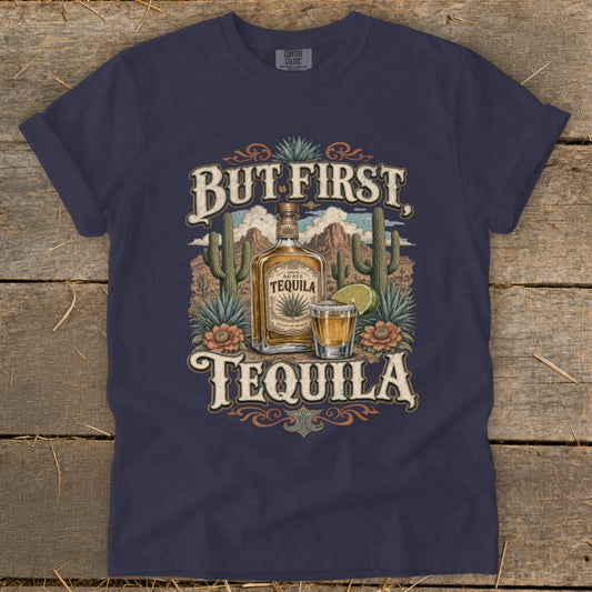 Dark blue t-shirt with "But First Tequila" text, agave bottle, shot glass, and desert scene.
