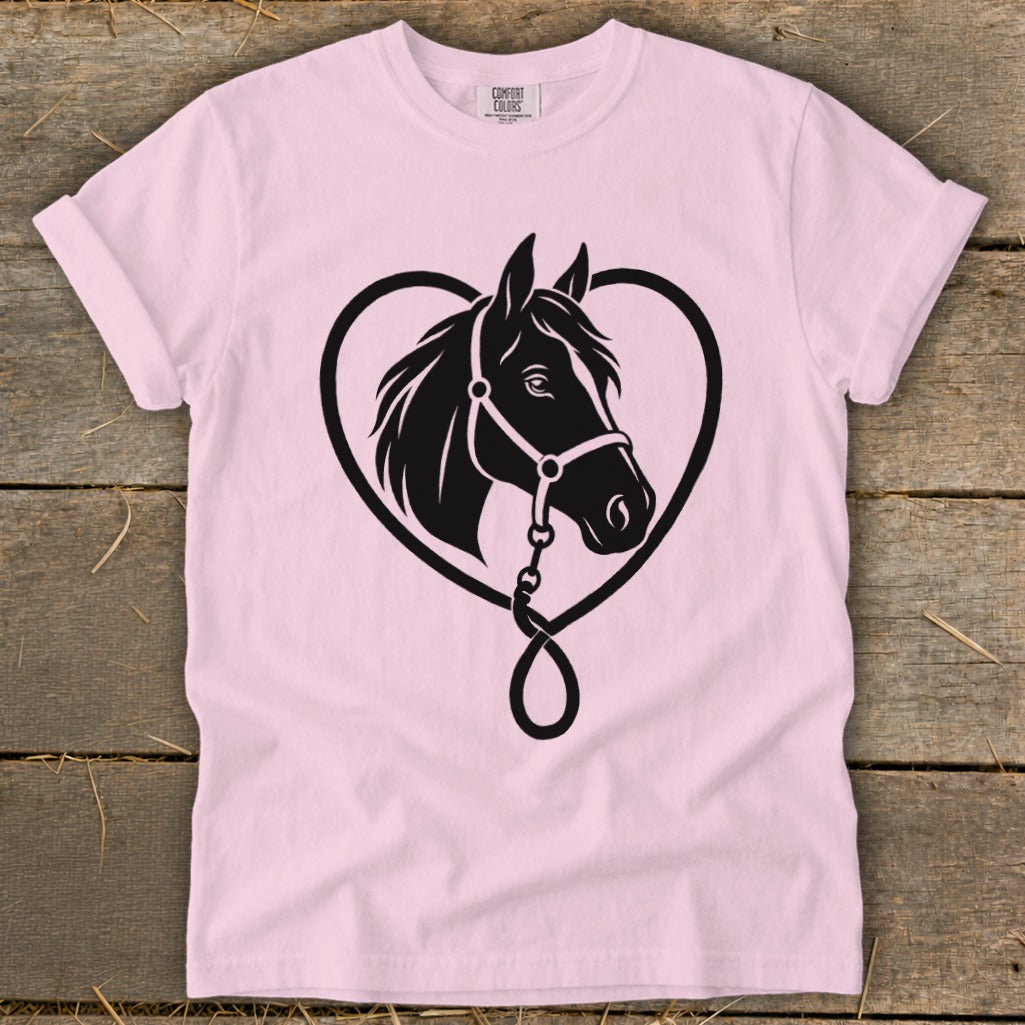 A light pink t-shirt featuring a black graphic of a horse head inside a heart.