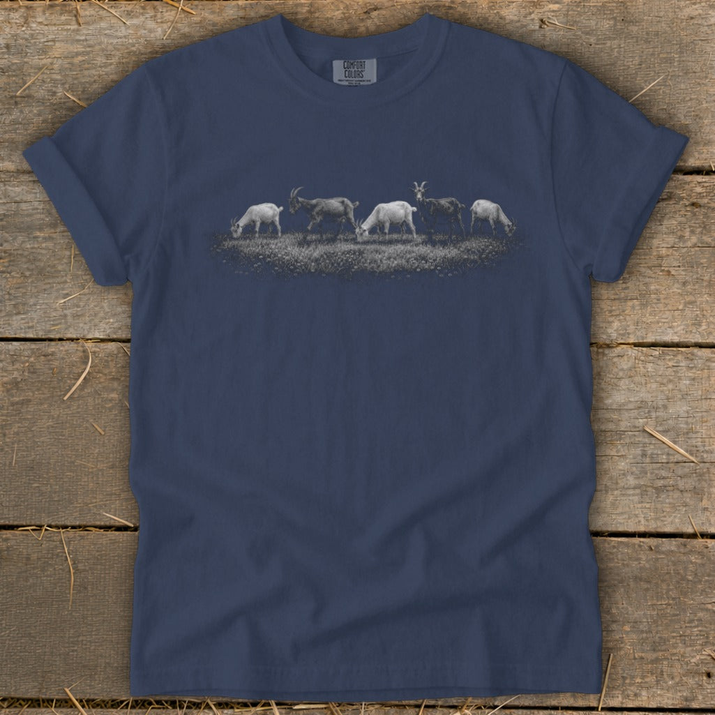 Five goats grazing in a field, design printed on a navy t-shirt.