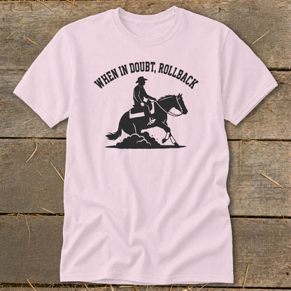 Pink t-shirt with black graphic of a cowboy on a horse, and text "WHEN IN DOUBT, ROLLBACK".