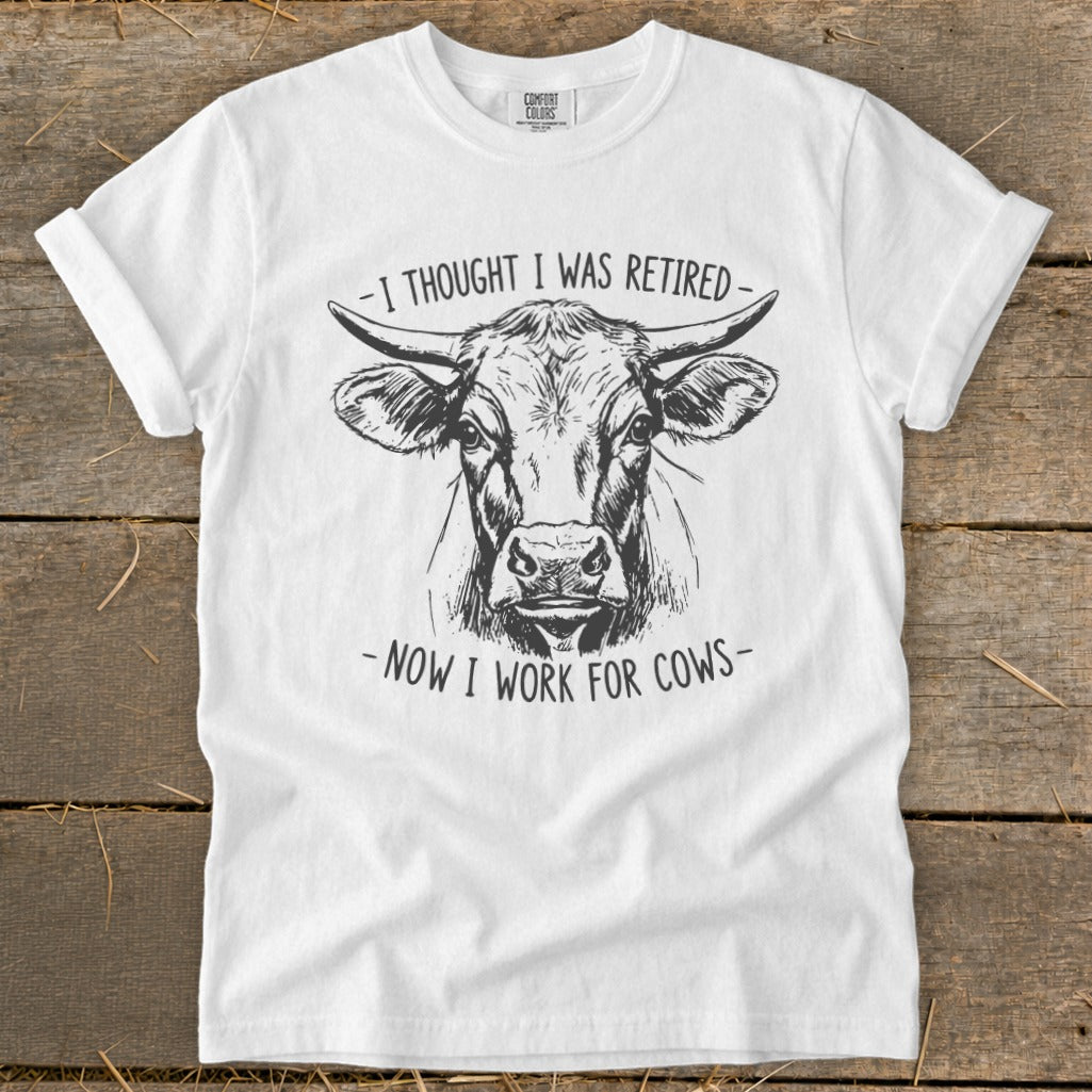 White t-shirt with sketch of cow and text "I thought I was retired - Now I work for cows".