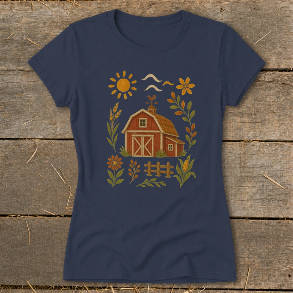 Navy t-shirt with a red barn, sun, flowers, and fence graphic.
