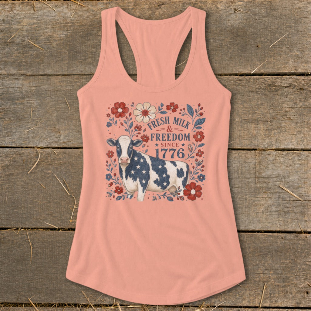 Peach tank top with a cow graphic and text "Fresh Milk & Freedom Since 1776".