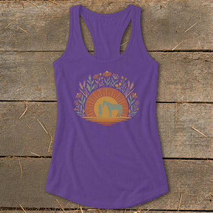 Purple tank top with girl and horse silhouette against sunset and floral border.
