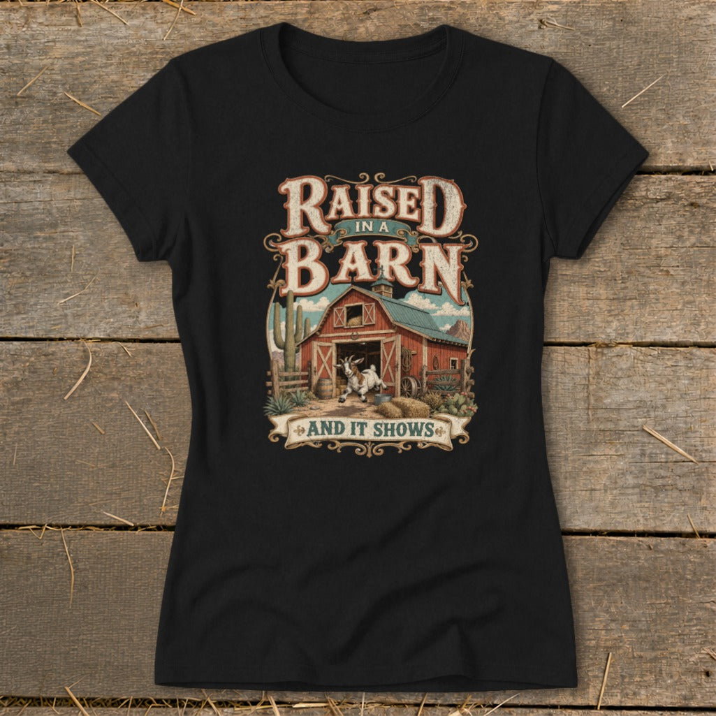 Black t-shirt with "Raised in a Barn And It Shows" text and barn graphic.