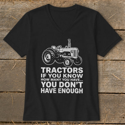Black t-shirt with white graphic of a tractor and text: "Tractors if you know how many you have... you don't have enough."