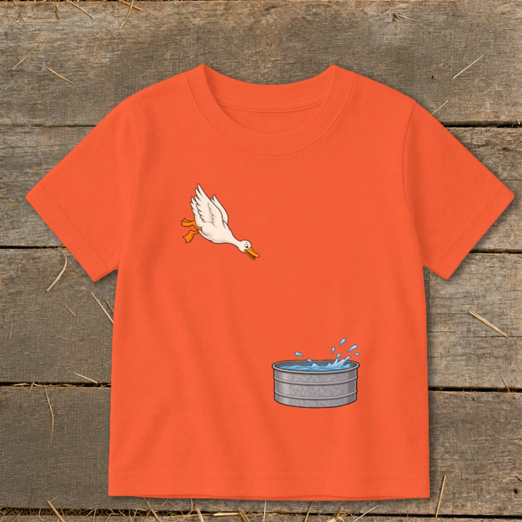 Orange t-shirt with cartoon duck jumping into a galvanized tub of water.