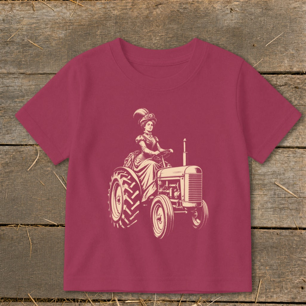 T-shirt with a vintage illustration of a woman in a hat driving a tractor.