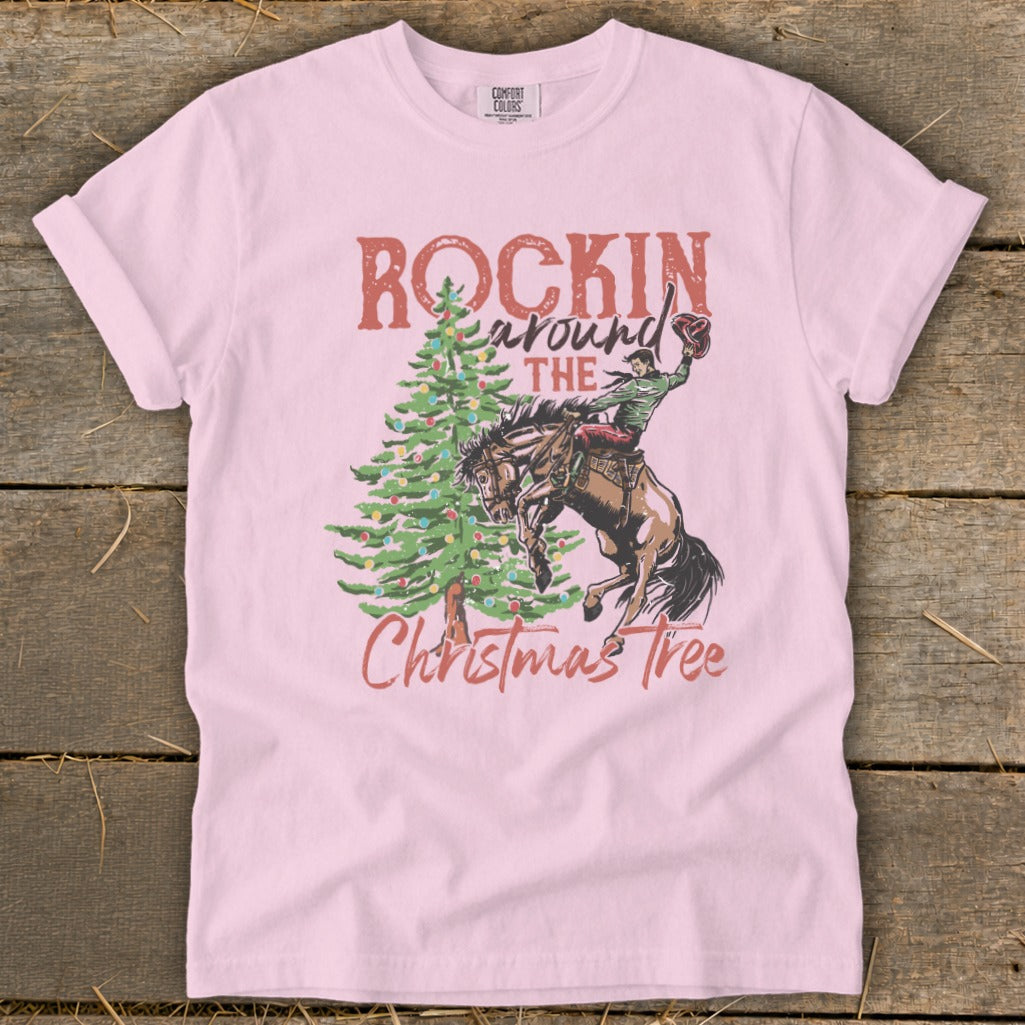 Pink t-shirt with "Rockin Around The Christmas Tree" text and rodeo scene.
