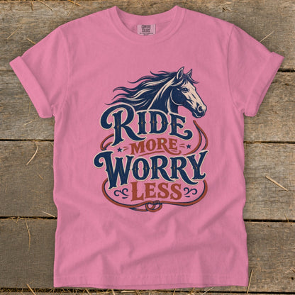 Pink t-shirt with a horse graphic and text reading "Ride More Worry Less".