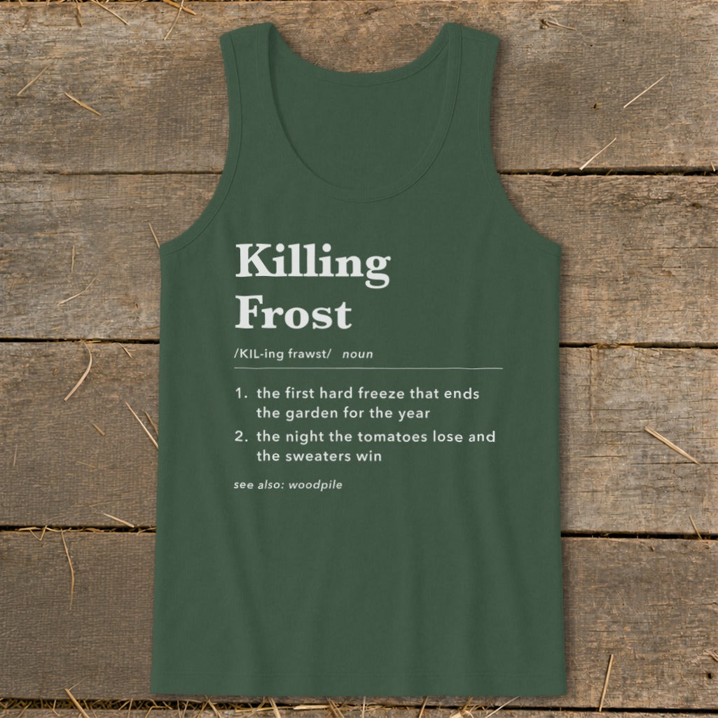 A dark green tank top printed with a humorous dictionary definition of a killing frost, laid flat on a rustic wooden background.