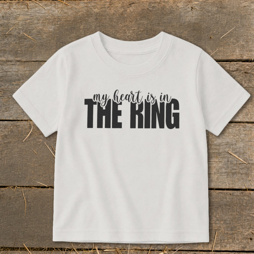 White t-shirt with black text reading "my heart is in THE RING".