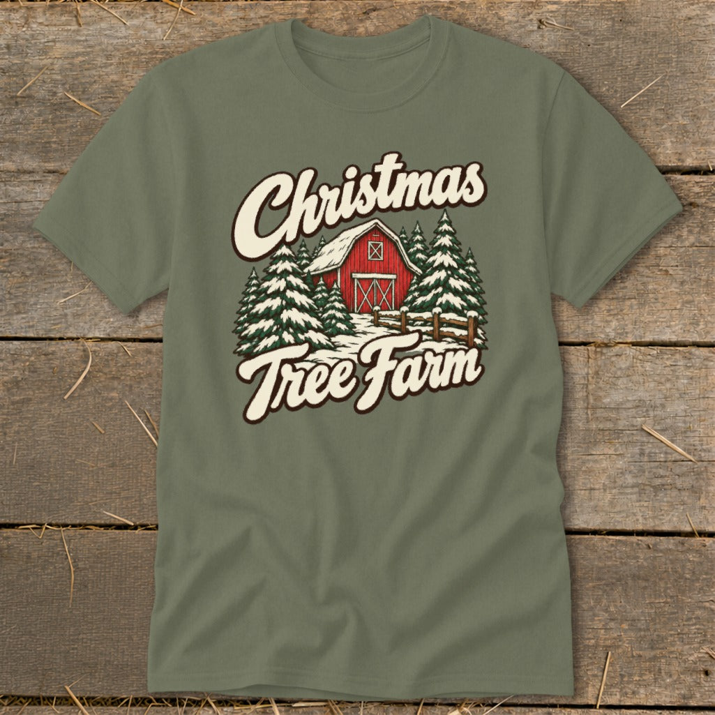 Green t-shirt graphic with red barn, snow, trees, and text "Christmas Tree Farm".