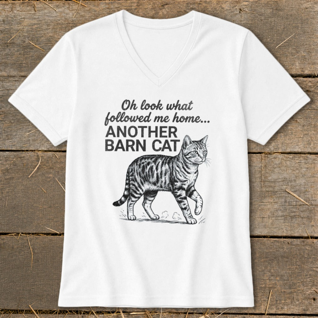 White V-neck t-shirt with black text "Oh look what followed me home... ANOTHER BARN CAT" and a cat illustration.