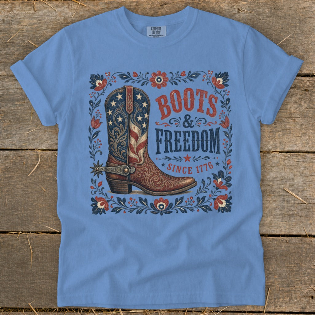 Light blue t-shirt with a boot graphic, "Boots & Freedom Since 1776" text.