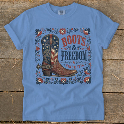 Light blue t-shirt with a boot graphic, "Boots & Freedom Since 1776" text.