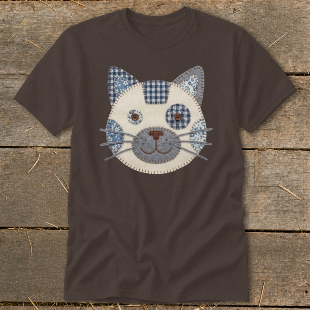 Brown t-shirt with a patched cat face applique in blue and white.