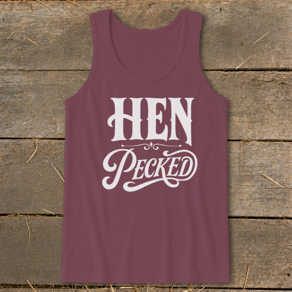Maroon tank top with white text "HEN Pecked" on rustic wood background.