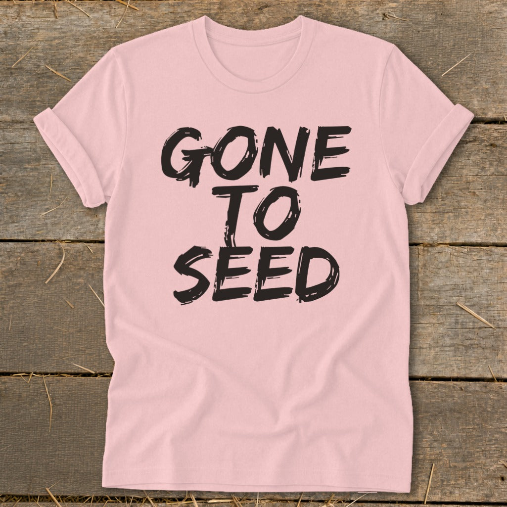 Pink t-shirt with black text that reads "GONE TO SEED".