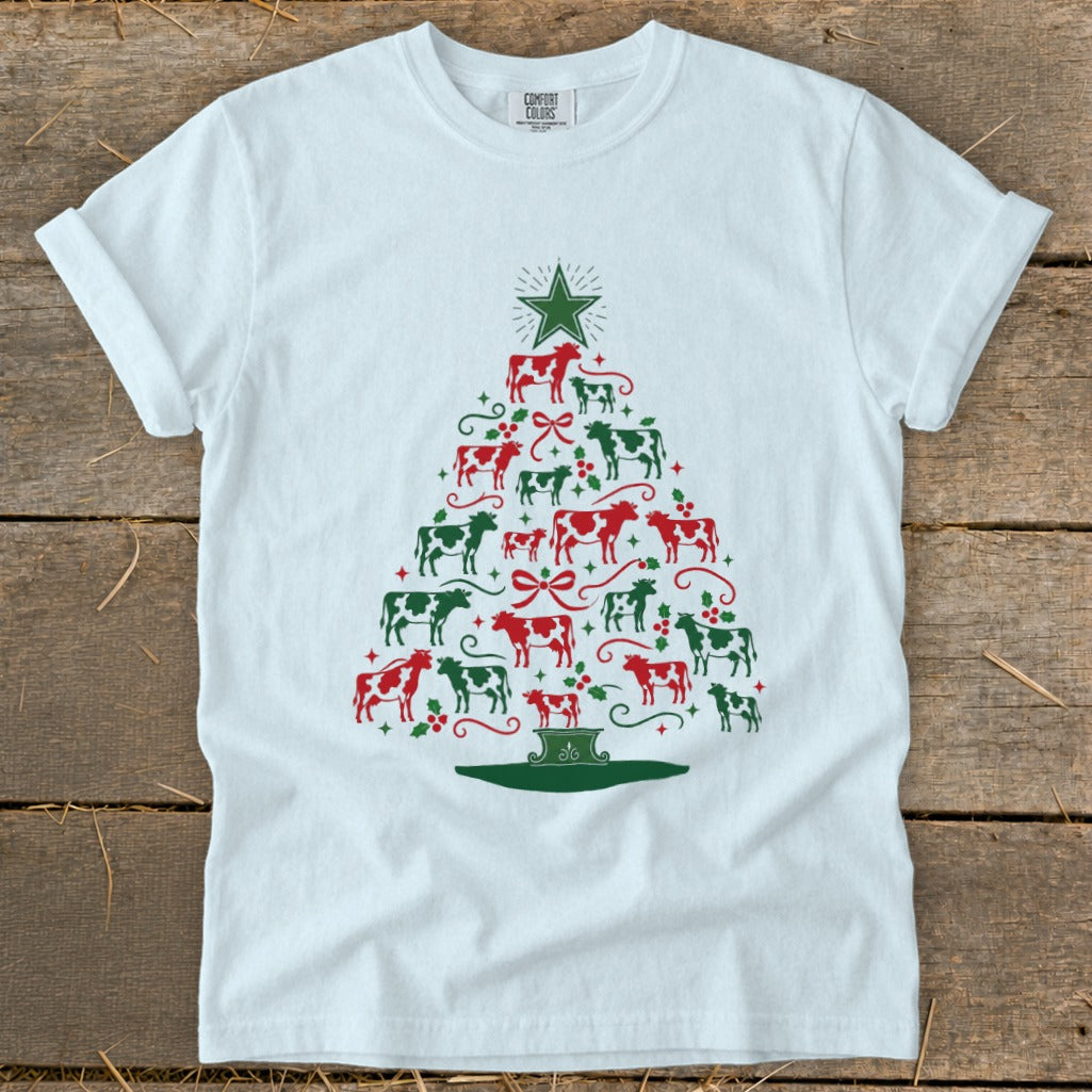 White t-shirt with Christmas tree design made of red and green cows.