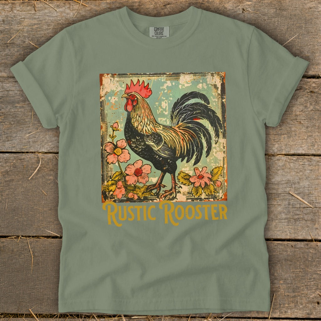 Green t-shirt with a distressed graphic of a rooster and pink flowers, reads "Rustic Rooster."